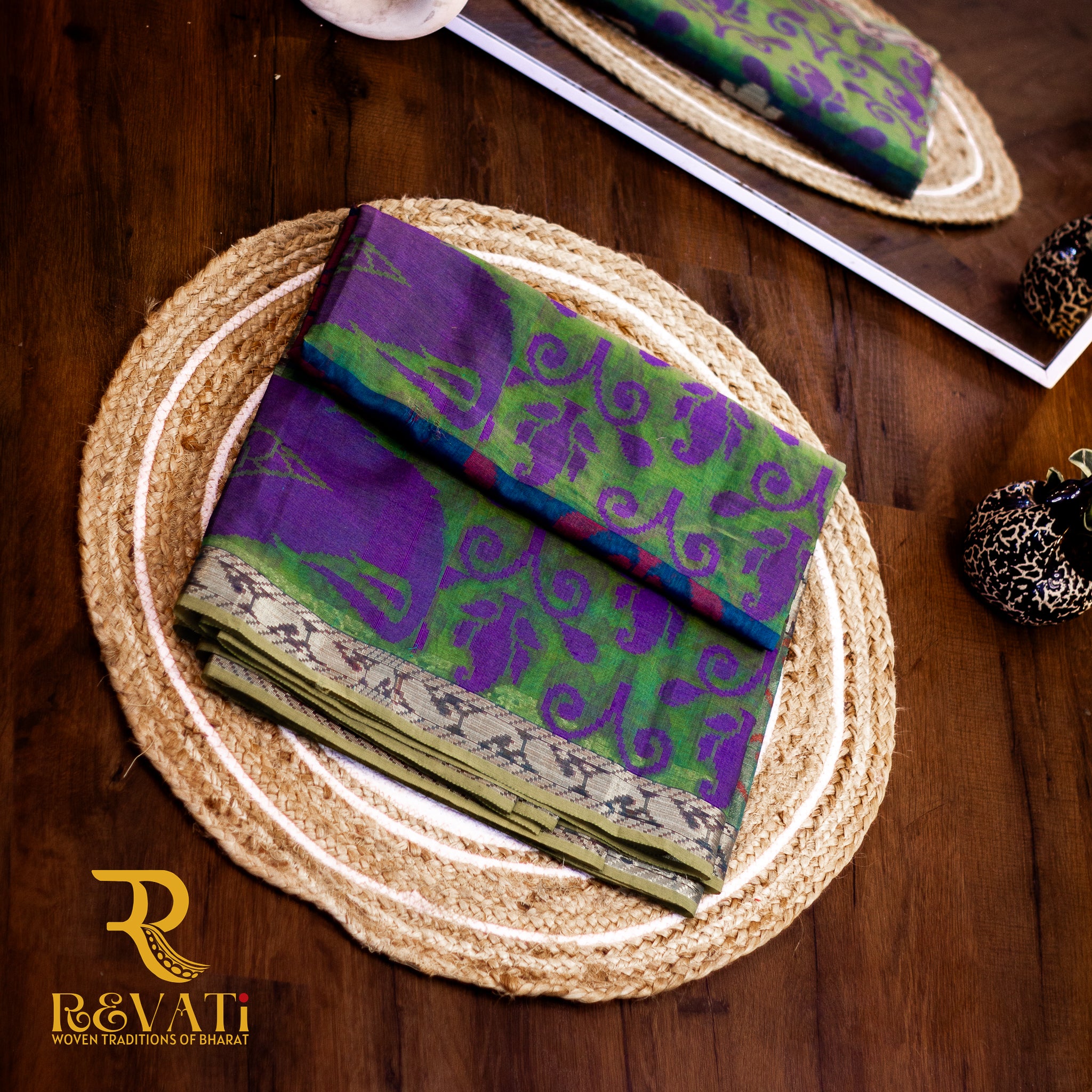 Multi-toned cotton-silk saree featuring Ikat-inspired woven bands, subtle metallic threadwork, and softly shimmering zari borders.