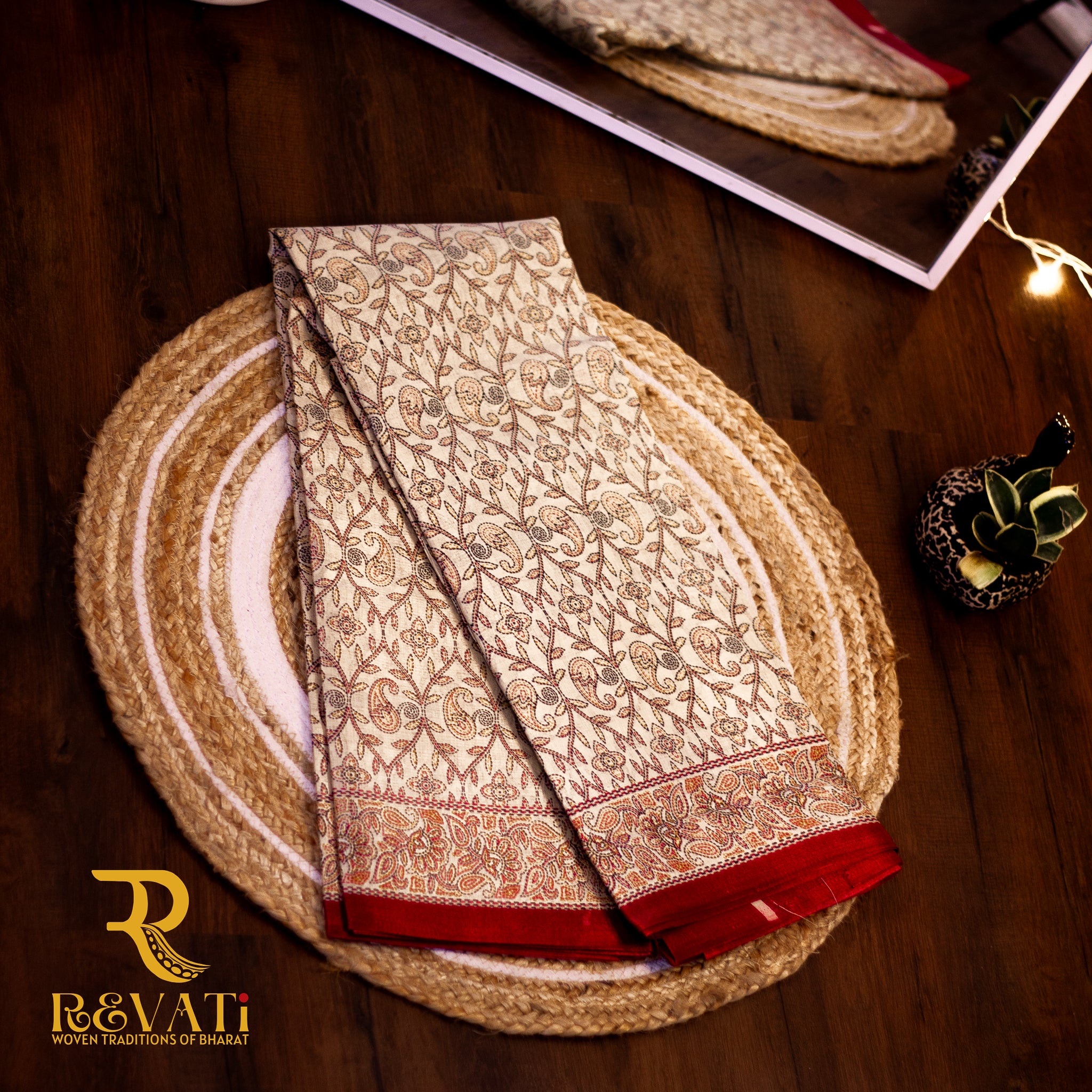 Beige Banarasi silk saree with intricate zari florals, maroon brocade borders, and a rich heritage pallu.