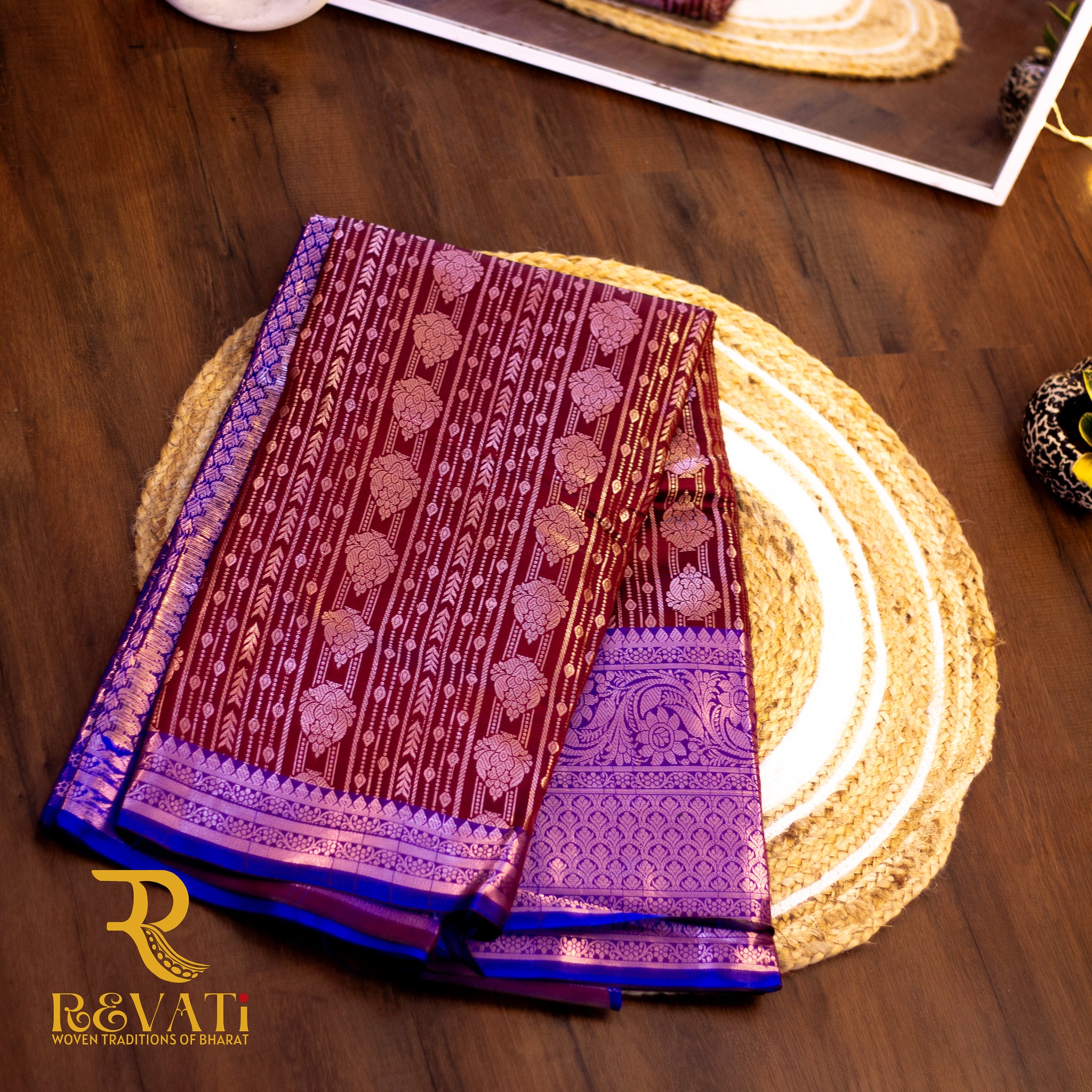 Royal blue and maroon jacquard silk saree featuring diamond-check motifs, vertical floral zari patterns, and broad silver-woven borders for a regal finish.