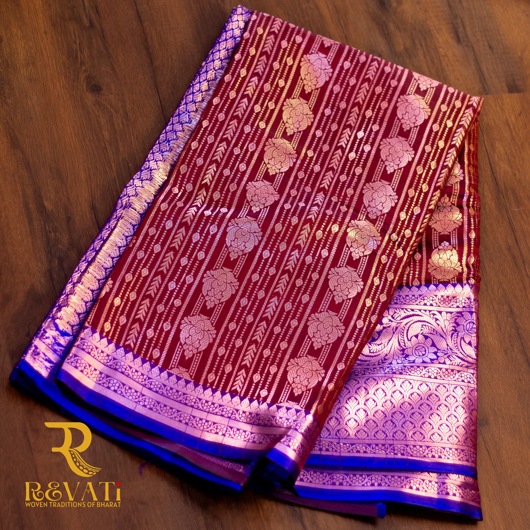 Royal blue and maroon jacquard silk saree featuring diamond-check motifs, vertical floral zari patterns, and broad silver-woven borders for a regal finish.