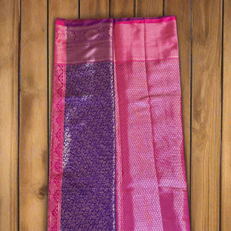 Pink handloom art silk saree with diamond weave, ornate zari borders, and a rich purple floral brocade pallu.
