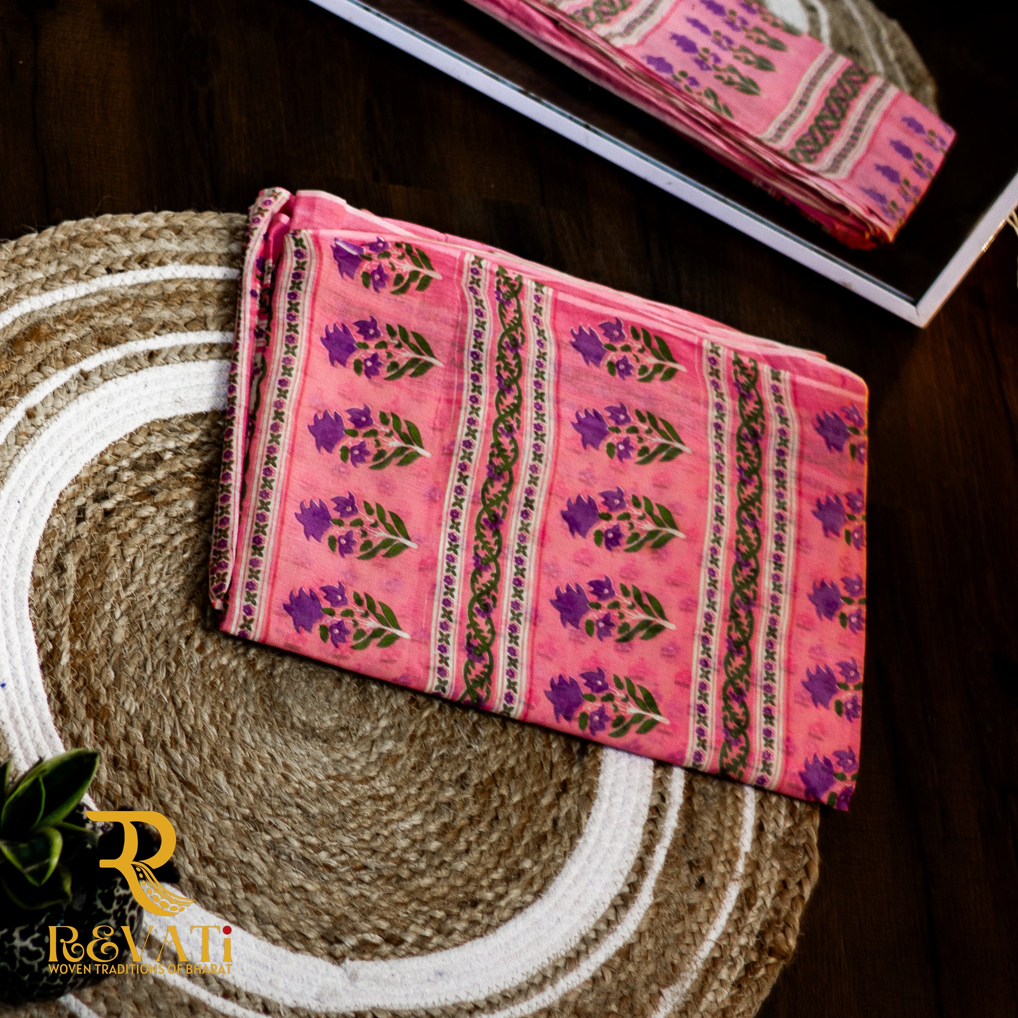 Ivory and pink soft cotton saree adorned with delicate floral bootis, graceful vine patterns, and subtle green-magenta borders for a fresh, elegant look.