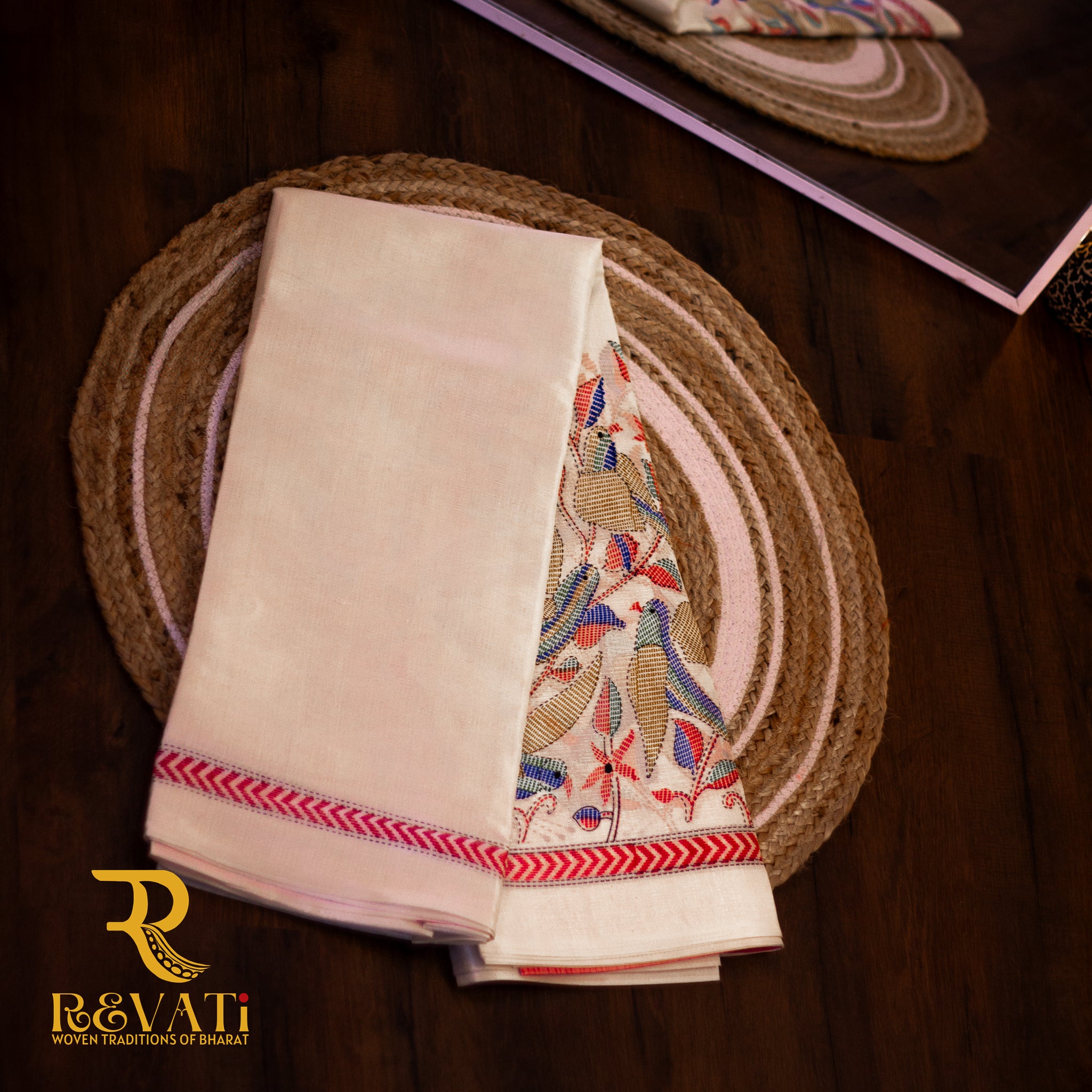 Bold crimson handloom cotton saree with multicolor Kalamkari edging and bird motifs.
