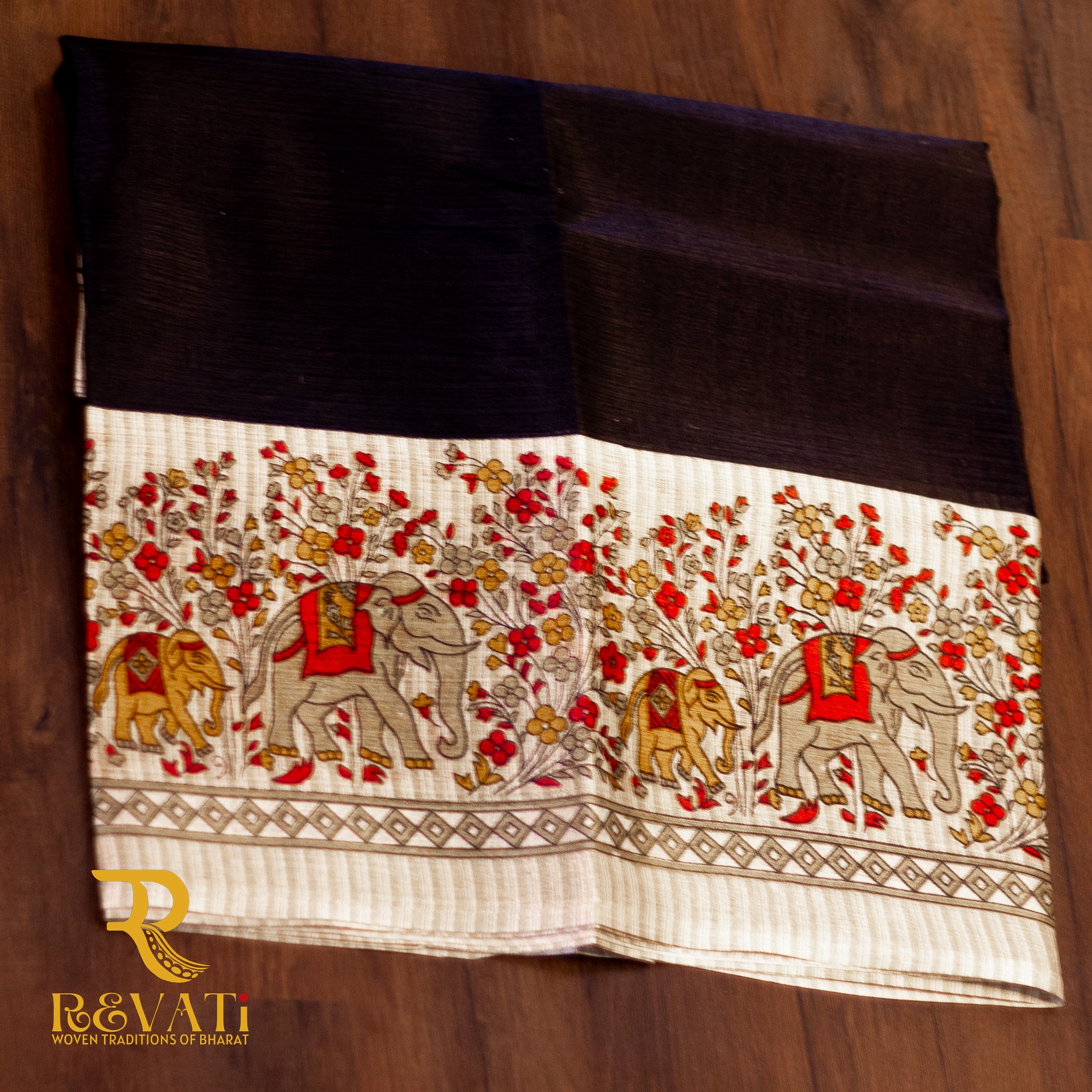 Jet black handloom silk saree with a beige Madhubani-inspired pallu featuring floral and elephant motifs.