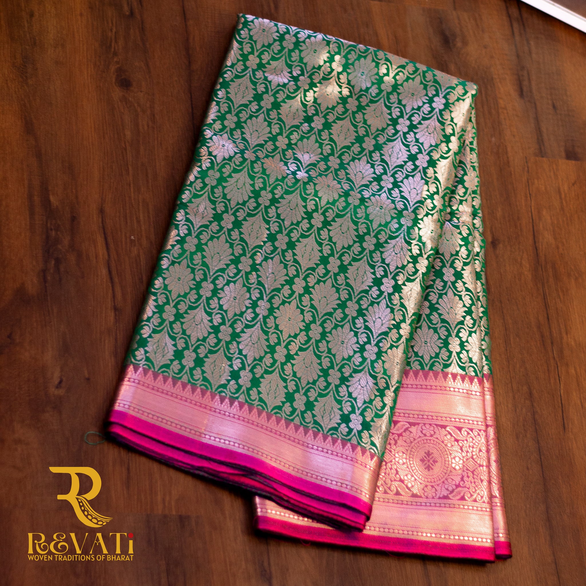 Emerald Green Kanjivaram Soft Silk Saree adorned with Golden Floral Motifs, a Rich Pink Brocade Border, and a Traditional Pallu